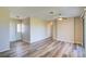 Open living room featuring modern flooring, a ceiling fan, and a bright front entrance at 7509 Mesa St, North Port, FL 34287