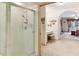 Bathroom featuring a glass enclosed shower and an adjacent vanity area with a comfortable stool at 8823 Crescent Forest Blvd, New Port Richey, FL 34654