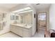 Bright bathroom featuring double sink vanity, a large mirror, and tiled floors at 8823 Crescent Forest Blvd, New Port Richey, FL 34654