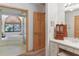 Bright bathroom featuring a soaking tub with tiled surround and a vanity with ample counter space at 8823 Crescent Forest Blvd, New Port Richey, FL 34654