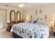 Comfortable bedroom with ceiling fan, seashell-themed décor, and matching mirrors on top of dresser at 8823 Crescent Forest Blvd, New Port Richey, FL 34654