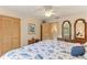 Spacious bedroom with ceiling fan, closet, and dresser with dual mirrors at 8823 Crescent Forest Blvd, New Port Richey, FL 34654
