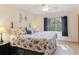Bright bedroom with large window, ceiling fan, and seashell-themed bedding at 8823 Crescent Forest Blvd, New Port Richey, FL 34654