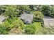 Overhead view of a home showcasing the three-car garage, tile roof and manicured landscaping at 9302 Deer Creek Dr, Tampa, FL 33647