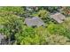 Aerial view of a home showcasing the tile roof, screened pool, mature trees and manicured landscaping at 9302 Deer Creek Dr, Tampa, FL 33647