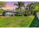Expansive backyard featuring lush green grass and mature trees for privacy and shade at 9302 Deer Creek Dr, Tampa, FL 33647