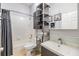 Cozy bathroom featuring a shower tub, a vanity, and storage racks at 9302 Deer Creek Dr, Tampa, FL 33647