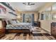 Bright bedroom featuring a ceiling fan, bedside fireplace, and sliding door access to a patio at 9302 Deer Creek Dr, Tampa, FL 33647