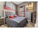 Comfortable bedroom with stylish decor, wood-look floors, and lots of natural light from the window at 9302 Deer Creek Dr, Tampa, FL 33647