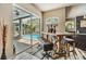 Dining area featuring table, chairs, and large glass doors leading to screened-in pool and patio at 9302 Deer Creek Dr, Tampa, FL 33647
