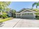 Charming home with a three-car garage and beautiful landscaping, offering great curb appeal at 9302 Deer Creek Dr, Tampa, FL 33647