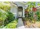 Charming front entrance with well-manicured landscaping and inviting walkway to the front door at 9302 Deer Creek Dr, Tampa, FL 33647