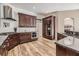 A kitchen featuring stainless steel appliances, granite countertops and warm wood cabinets and flooring at 9302 Deer Creek Dr, Tampa, FL 33647