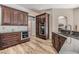 A kitchen featuring stainless steel appliances, granite countertops and warm wood cabinets and flooring at 9302 Deer Creek Dr, Tampa, FL 33647