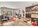 Open-concept living room with sliding glass doors to the pool and updated flooring at 9302 Deer Creek Dr, Tampa, FL 33647