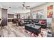 Open-concept living room with comfortable seating, views of the kitchen and lanai, and contemporary decor at 9302 Deer Creek Dr, Tampa, FL 33647