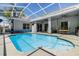 Inviting screened pool with patio and outdoor dining area is perfect for relaxing and entertaining at 9302 Deer Creek Dr, Tampa, FL 33647