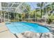 Sparkling screened-in pool with a spacious deck and lush greenery surrounding the area at 9302 Deer Creek Dr, Tampa, FL 33647