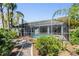 Beautiful screened pool surrounded by lush landscaping offers privacy and a tropical ambiance at 9302 Deer Creek Dr, Tampa, FL 33647