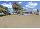Spacious backyard features lush greenery and a screened patio with a basketball hoop at 9711 Wydella St, Riverview, FL 33569