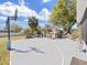 Backyard basketball court with a shaded seating area and landscaping under a bright blue sky at 9711 Wydella St, Riverview, FL 33569