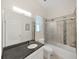 Bathroom with a sleek vanity, shower over tub, and ample natural light, combining practicality and design at 9711 Wydella St, Riverview, FL 33569