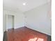 Bedroom featuring hardwood floors, closet, and natural light, perfect for rest and relaxation at 9711 Wydella St, Riverview, FL 33569