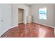 Bright bedroom with a wood floor, closet, chest of drawers, and plenty of natural light from the window at 9711 Wydella St, Riverview, FL 33569