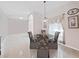 Formal dining room with modern chandelier, seating for six, and ample light at 9711 Wydella St, Riverview, FL 33569
