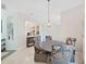 Bright dining area with modern chandelier, seating for four, and open access at 9711 Wydella St, Riverview, FL 33569
