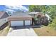 Charming home featuring a well-manicured lawn, a two-car garage, and a welcoming entryway at 9711 Wydella St, Riverview, FL 33569