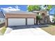 Charming home featuring a two-car garage, fountain, and inviting entryway at 9711 Wydella St, Riverview, FL 33569