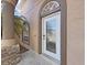 Stunning front door featuring decorative glass, arched trim, and stone accents at 9711 Wydella St, Riverview, FL 33569