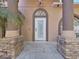 Up close of the white front door entrance and stone column accents at 9711 Wydella St, Riverview, FL 33569