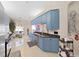 Bright kitchen featuring blue cabinets and granite countertops, with breakfast nook view at 9711 Wydella St, Riverview, FL 33569