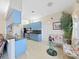 Kitchen with blue cabinets, stainless steel appliances, granite countertops, and adjacent dining area at 9711 Wydella St, Riverview, FL 33569