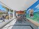 Open patio with a mural, dining area, ceiling fan, and access to the backyard and outdoor spaces at 9711 Wydella St, Riverview, FL 33569