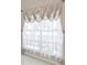 Elegant window with stylish valance and soft sheer curtains at 9711 Wydella St, Riverview, FL 33569