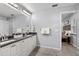 Bathroom with double sinks, granite countertops, decorative lighting and views to the primary bedroom at 1039 23Rd St, Sarasota, FL 34234
