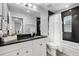 Cozy bathroom features a dark granite countertop and shower with a white curtain at 1039 23Rd St, Sarasota, FL 34234