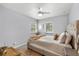 Well-lit bedroom featuring a modern ceiling fan, neutral paint and carpet, and multiple windows at 1039 23Rd St, Sarasota, FL 34234