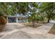 Blue home with spacious driveway and tropical landscaping at 1039 23Rd St, Sarasota, FL 34234
