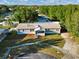 An aerial shot of the home highlighting its landscaping, roof, and driveway at 10404 Hawk Ct, Riverview, FL 33578