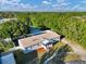 An aerial view of the home showcases the roof, landscaping, and surrounding wooded area at 10404 Hawk Ct, Riverview, FL 33578