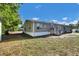 Home exterior shows a spacious backyard with green grass and a home view at 10404 Hawk Ct, Riverview, FL 33578