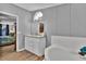 Bright bathroom featuring double sinks, tub, and wood-look flooring at 10404 Hawk Ct, Riverview, FL 33578