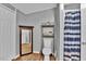 Neutral bathroom featuring a toilet, storage shelving, and shower with blue curtain at 10404 Hawk Ct, Riverview, FL 33578