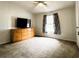 Neat bedroom featuring carpeted floor, natural light, dresser, and curtains at 10404 Hawk Ct, Riverview, FL 33578