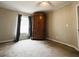 Bedroom with natural light, carpeted floor, a wardrobe, and neutral decor at 10404 Hawk Ct, Riverview, FL 33578
