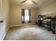 Simple bedroom with carpeted floor, a desk, and natural light at 10404 Hawk Ct, Riverview, FL 33578